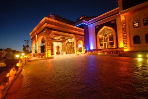 a building lit up at night with purple lights at Suhan Cappadocia Hotel & Spa in Avanos