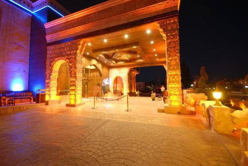 a building with a lit up patio at night at Suhan Cappadocia Hotel & Spa in Avanos