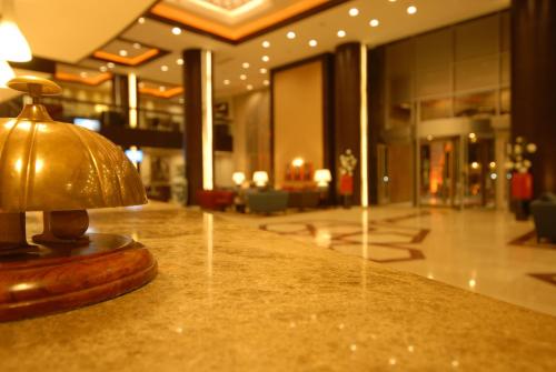 a gold lamp sitting on a counter in a lobby at Suhan Cappadocia Hotel & Spa in Avanos