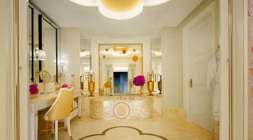 a bathroom with a large tub and a large mirror at Wynn Palace in Macau