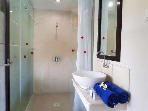 a bathroom with a sink and a shower at Sanur Agung Hotel in Sanur