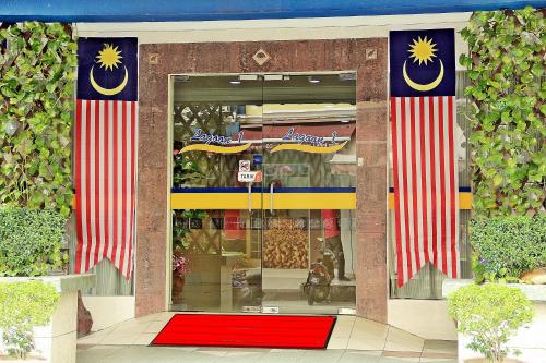 a store front with two american flags and a red carpet at Sun Inns Hotel Lagoon near Sunway Lagoon Theme Park in Petaling Jaya
