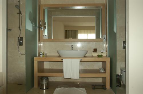 a bathroom with a sink and a mirror at Lvzz Hotel in Bodrum City