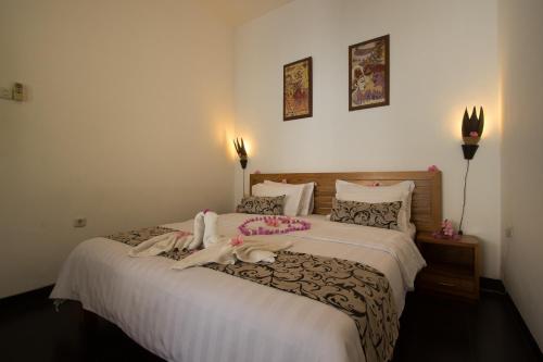 a bedroom with a large bed with towels on it at Dream Estate Resort in Senggigi 