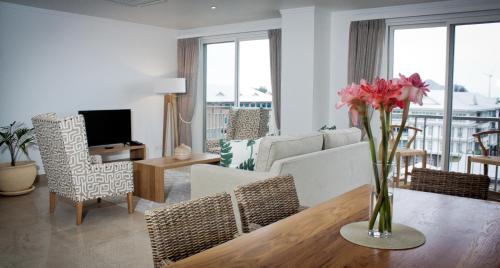 a living room with a vase of flowers on a table at The Quadrant Luxury Apartments in Victoria