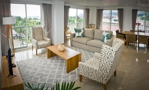 a living room with a couch and chairs and a table at The Quadrant Luxury Apartments in Victoria