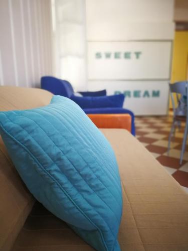 a blue pillow sitting on top of a bed at Giada in Moneglia