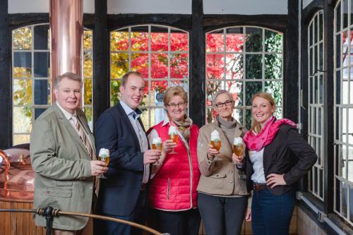 a group of people holding glasses of wine at Esloher Brauhaus in Eslohe