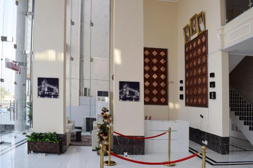 a large room with a red ribbon on the floor at Opera Suites in Muhayil