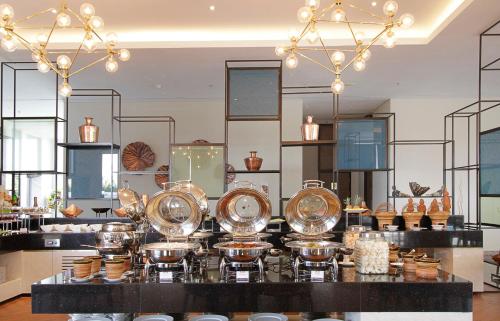 a store with a bunch of plates on a counter at Swiss-Belinn Airport Surabaya in Sidoarjo