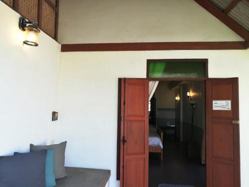 a room with a door leading to a bedroom at Koh Munnork Private Island in Ko Munnork