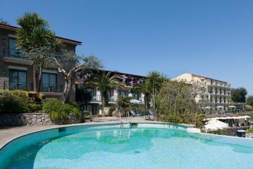a large swimming pool in front of a building at Grand Hotel Capodimonte in Sorrento