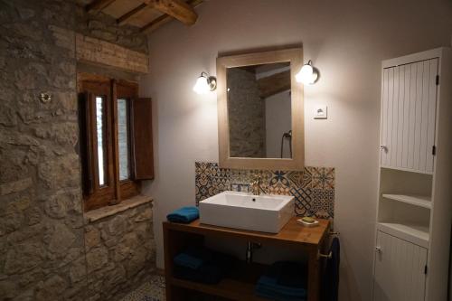 a bathroom with a sink and a mirror at Mas Roca Del Mill in Perafita