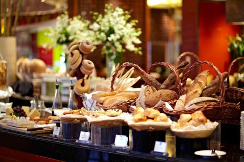 a display of bread and pastries on a table at Kempinski Hotel Shenzhen - 24 Hours Stay Privilege, Subject to Hotel Inventory in Shenzhen