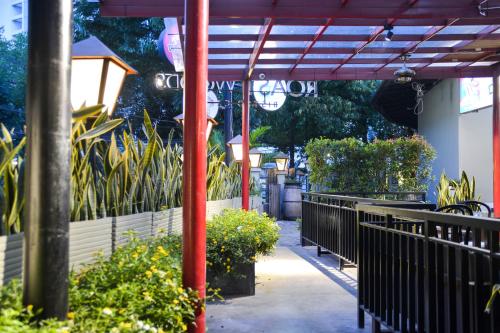 a patio with a row of benches and plants at Treehouse Suites - Boutique Serviced Apartment in Jakarta