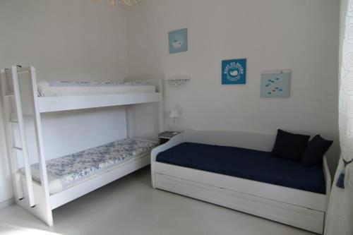 a bedroom with two bunk beds and a ladder at Sea cottage in pinewood in Ginosa Marina
