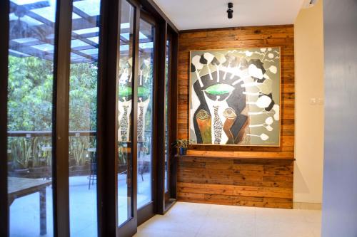 a room with glass doors and a painting on the wall at Treehouse Suites - Boutique Serviced Apartment in Jakarta