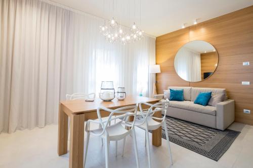 a living room with a table and a couch at Metropol Ceccarini Suite - Luxury apartments in Riccione