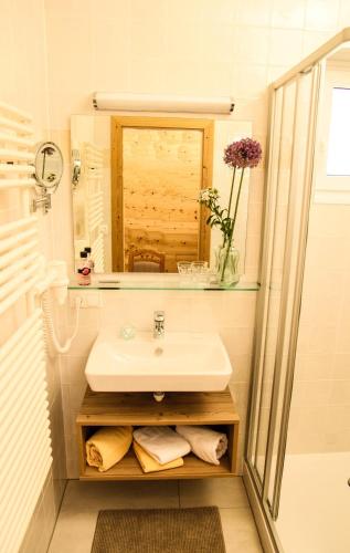 a bathroom with a sink and a mirror at PEOPLE'S Hotel in Kaprun
