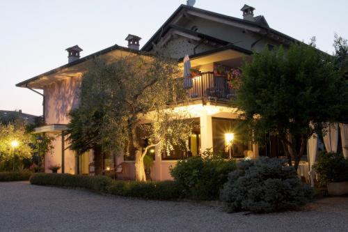 a large house with a tree in front of it at Hotel Clodia - Adults Only in Sirmione