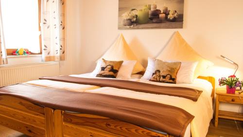 a bedroom with a bed with two teddy bears on it at Auszeit-Wohnungen in Aidenbach