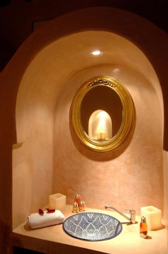 a bathroom with a sink and a mirror at Riad Palais Des Princesses & Spa in Marrakesh