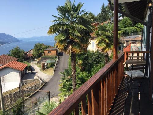 a balcony of a house with a palm tree at Tower 44 in Luino