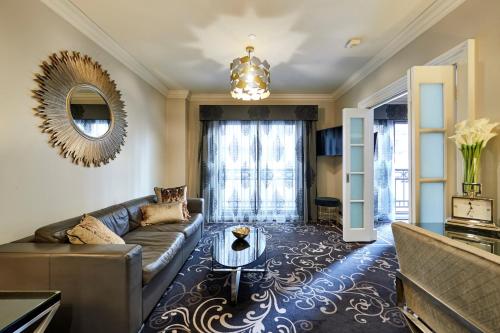 a living room with a couch and a table at The Sebel Melbourne Flinders Lane in Melbourne