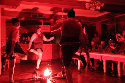 a group of men dancing in a room at Aktiv-Hotel Traube am Mieminger Sonnenplateau in Wildermieming