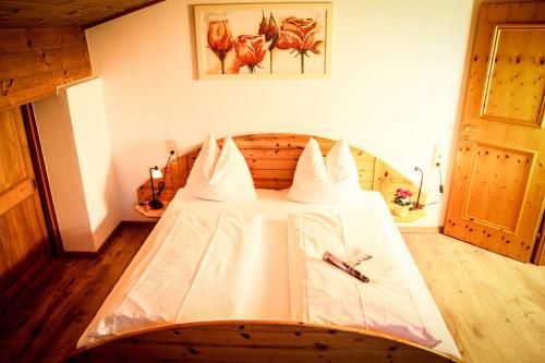 a bedroom with a bed with white sheets at PEOPLE'S Hotel in Kaprun
