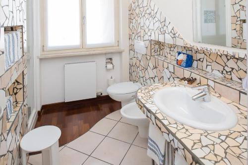 a bathroom with a sink and a toilet at Blue Lake Residence - Bardolino in Bardolino