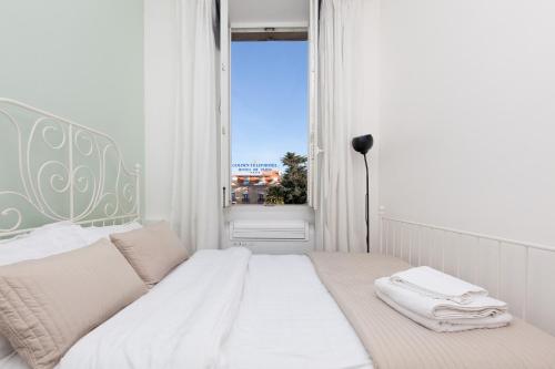 une chambre blanche avec un lit et une fenêtre dans l'établissement Apartment29, à Cannes