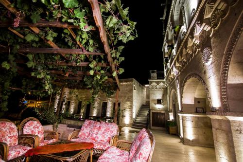 a room with chairs and tables in a building at Roma Cave Suite in Goreme