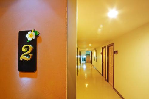 a hallway with a number three sign on the wall at Floral Shire Suvarnabhumi Airport in Lat Krabang