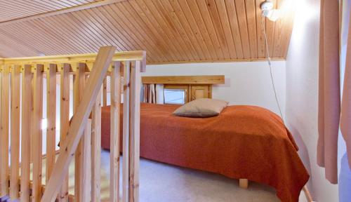 a bedroom with a bed with a wooden ceiling at Holiday Club Pyhä Apartments in Pyhätunturi