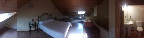 a bedroom with a bed and a sink in a room at Parque Sierra Norte in Rascafría