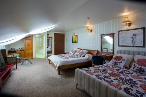 a hotel room with two beds and a mirror at Pažaislis Park Hotel in Kaunas