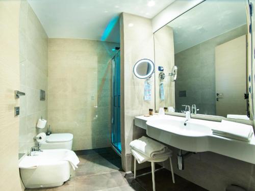 a bathroom with a sink and a toilet and a shower at Hotel Continental in Taormina