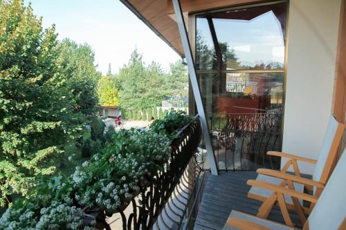 an open balcony with a fence and plants at Pažaislis Park Hotel in Kaunas