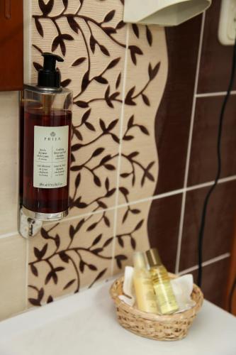 a bottle of soap sitting next to a basket of soap at Pažaislis Park Hotel in Kaunas