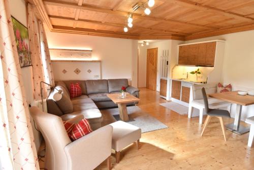 a living room with a couch and a table at Landhaus Trinker in Schladming