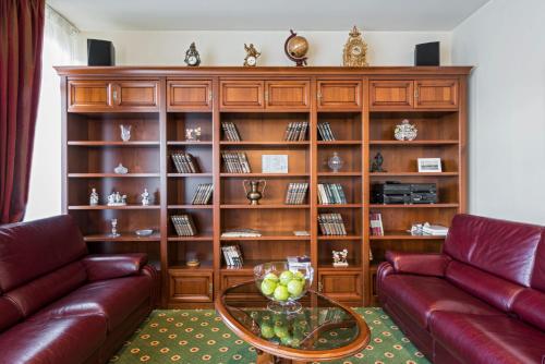 a living room with a couch and a glass table at BEST BALTIC Kaunas in Kaunas