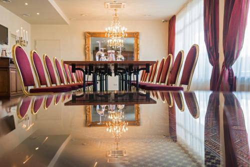 a dining room with a table and chairs and a mirror at BEST BALTIC Kaunas in Kaunas