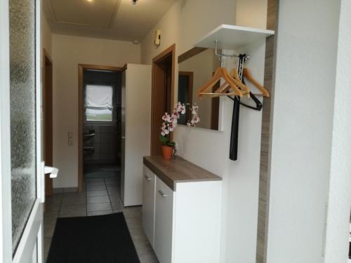 a kitchen with white cabinets and a counter top at Ferienhaus Apfelblüte in Twielenfleth
