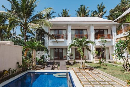 an exterior view of a house with a swimming pool at Gerke House in Ubud