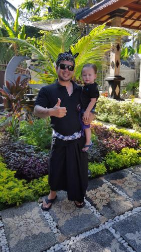 a man is holding a baby in his arms at Villa Jackson in Tejakula