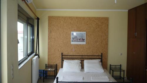 a bedroom with a bed with two white pillows at Hostel Stylianos Kissamos in Kissamos