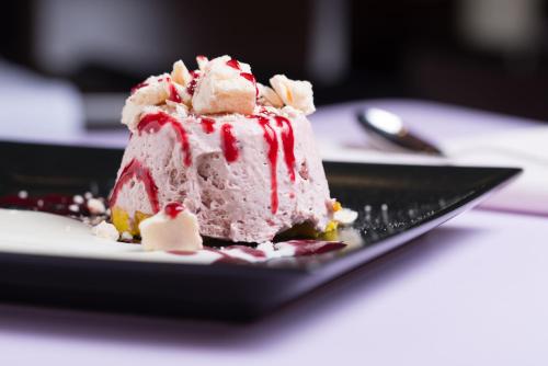 a piece of cake on a plate on a table at Hotel Viest in Vicenza