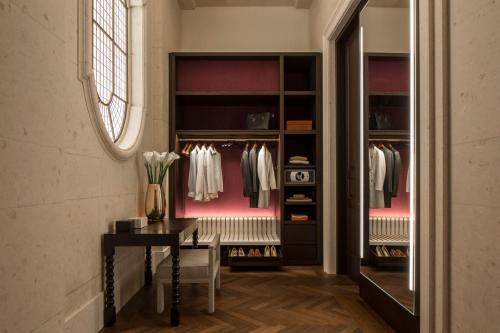 a walk in closet with a table and a desk at Four Seasons Hotel London at Tower Bridge in London