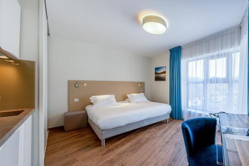 a hotel room with a bed and a window at All Suites Appart Hôtel - Bordeaux Centre Gare in Bordeaux